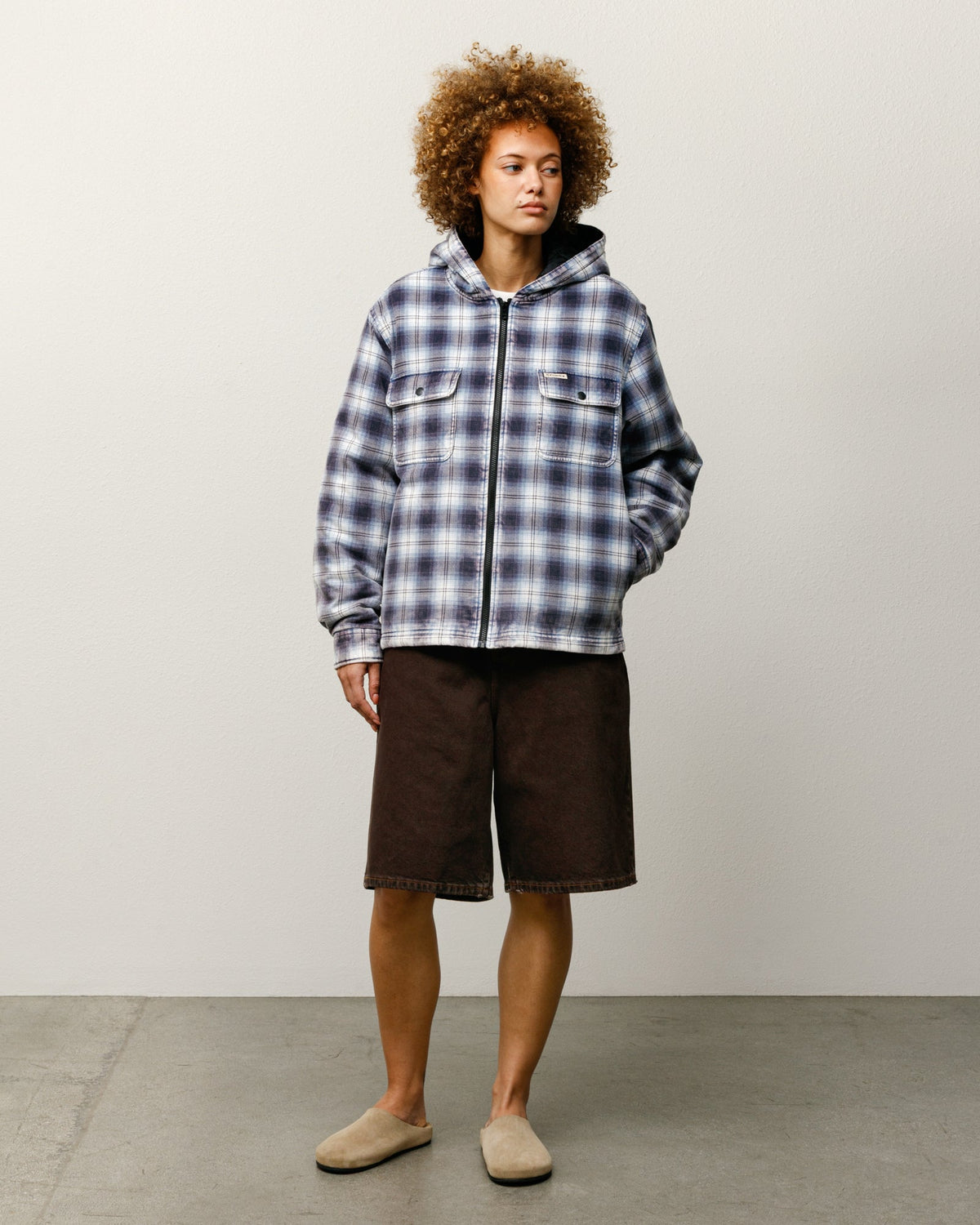 ZIP HOODED PLAID SHIRT jacket in blue with zip front and hood, styled on model; Stüssy woven label at chest pocket.