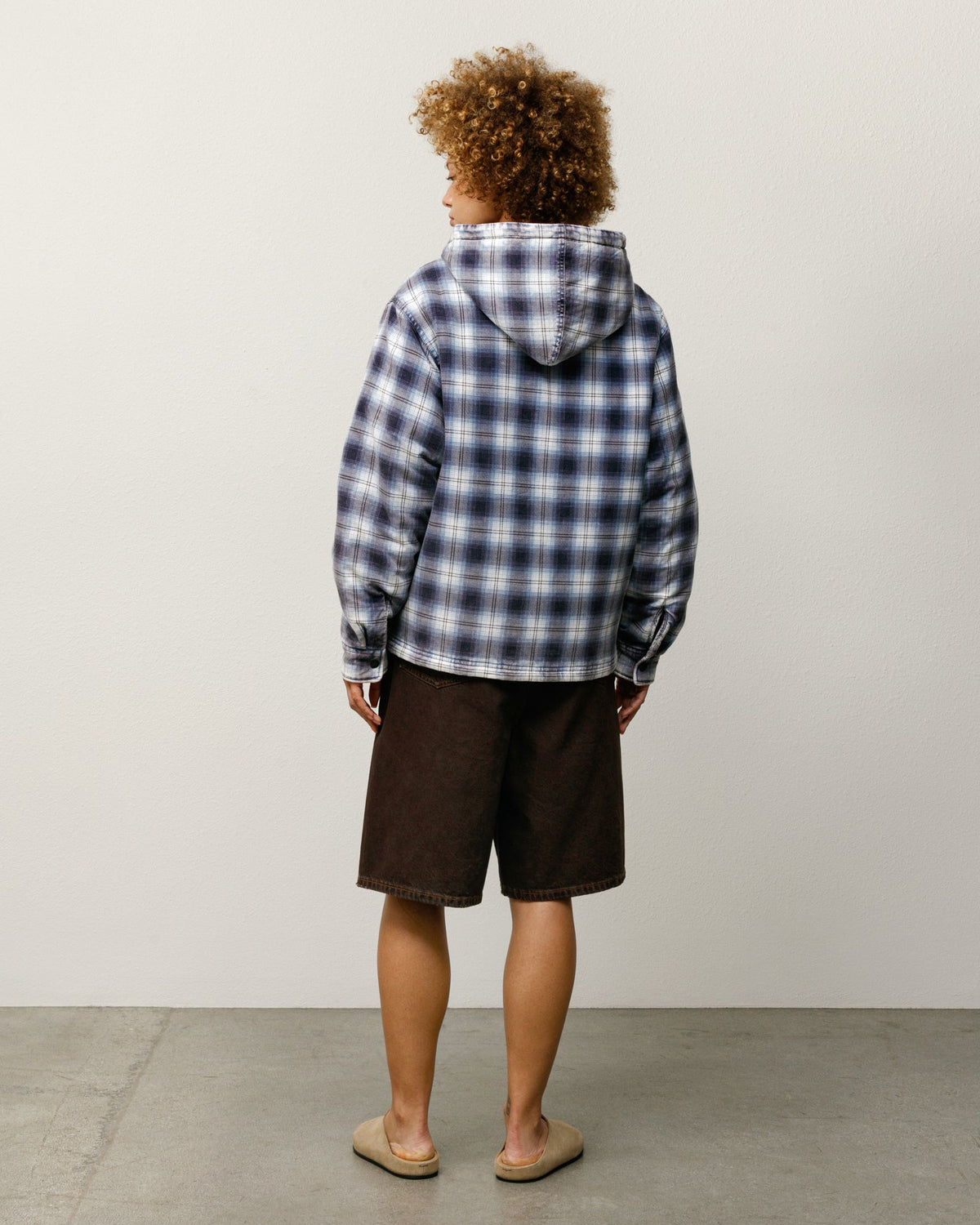 Stüssy ZIP HOODED PLAID SHIRT Outerwear in Blue, back view on model wearing hooded plaid jacket