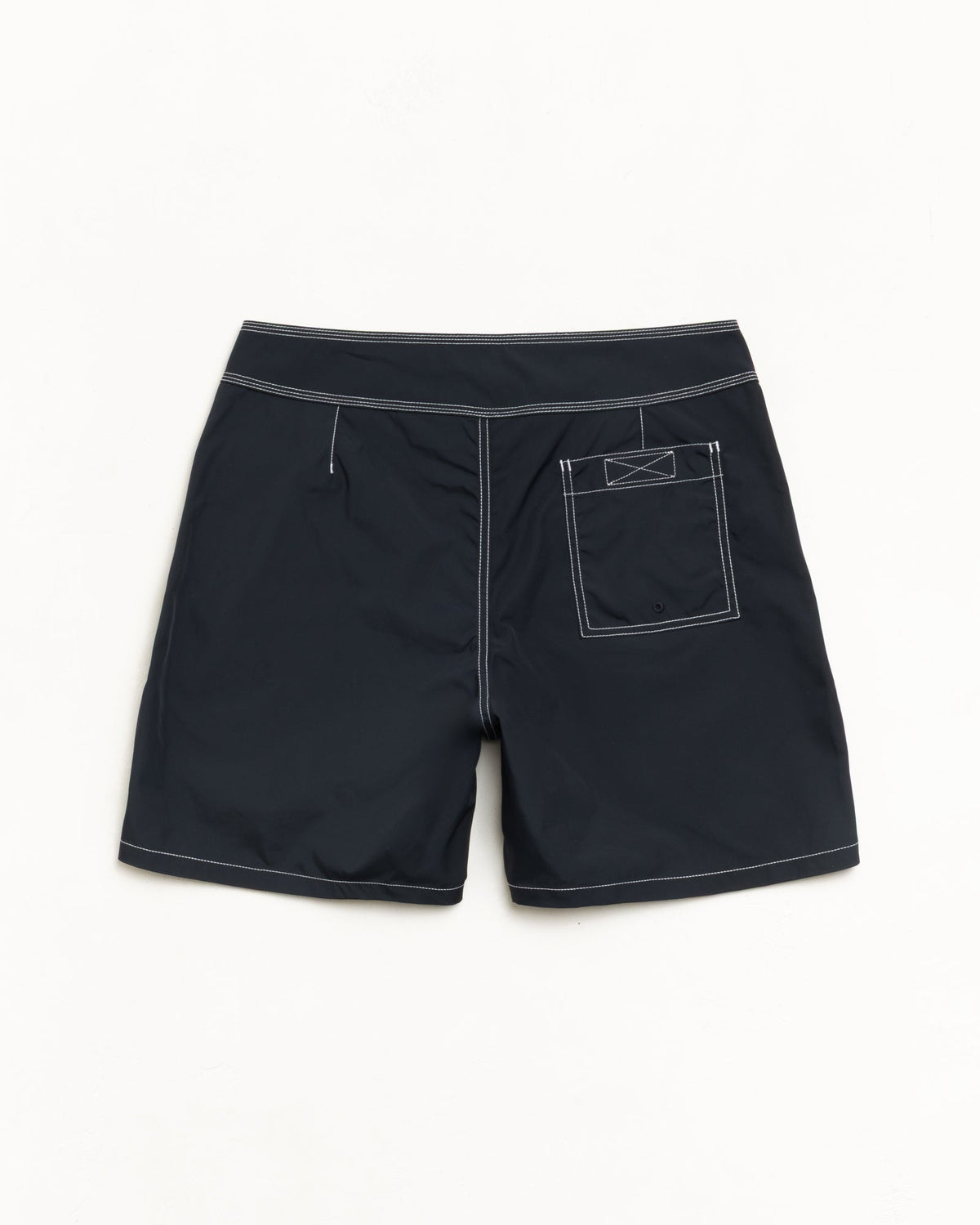 Coastal Board Short in Black, back flat with contrast stitching and a rear patch pocket