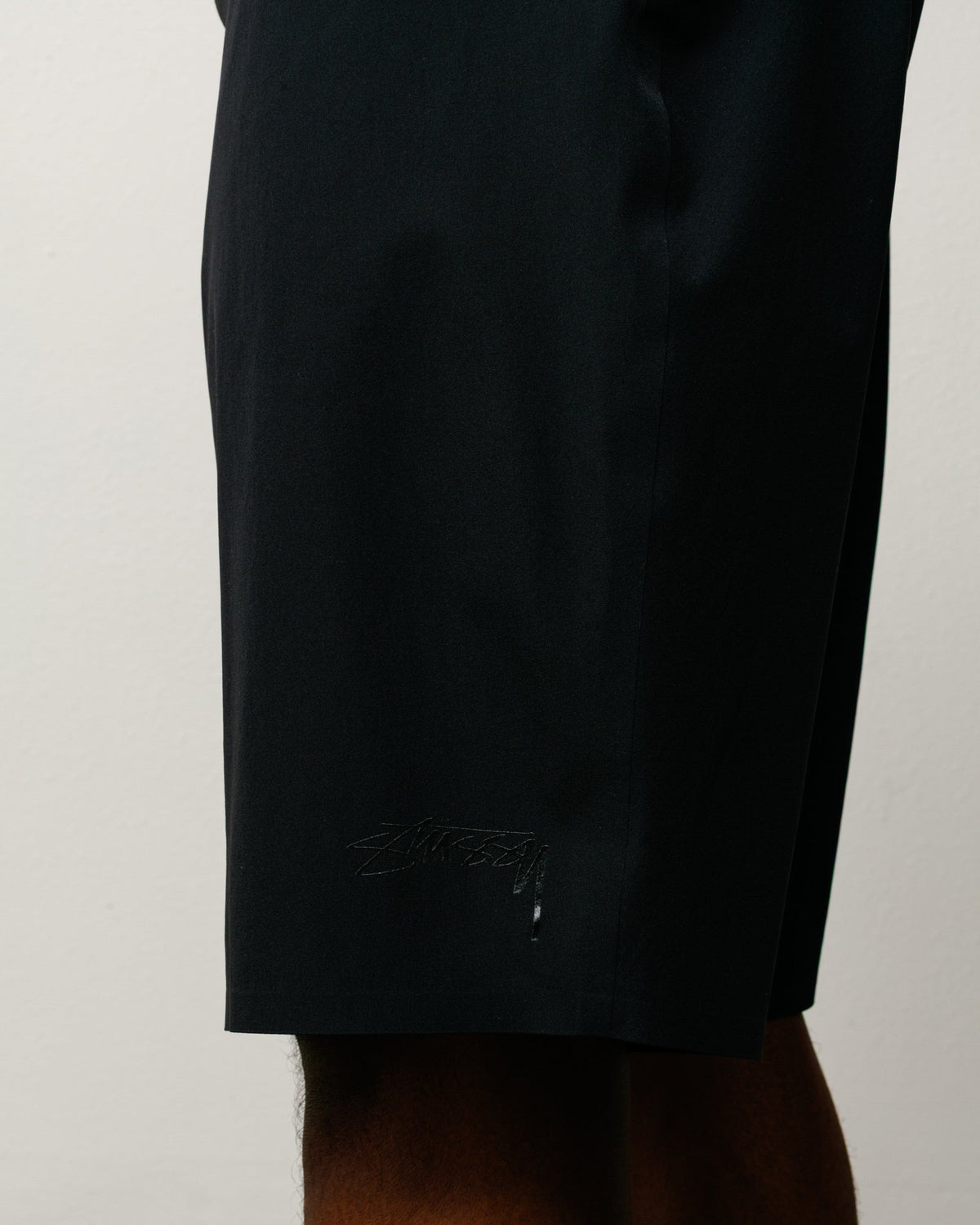 Peak Board Short in Black, stretch nylon boardshort with tonal Stüssy logo at hem