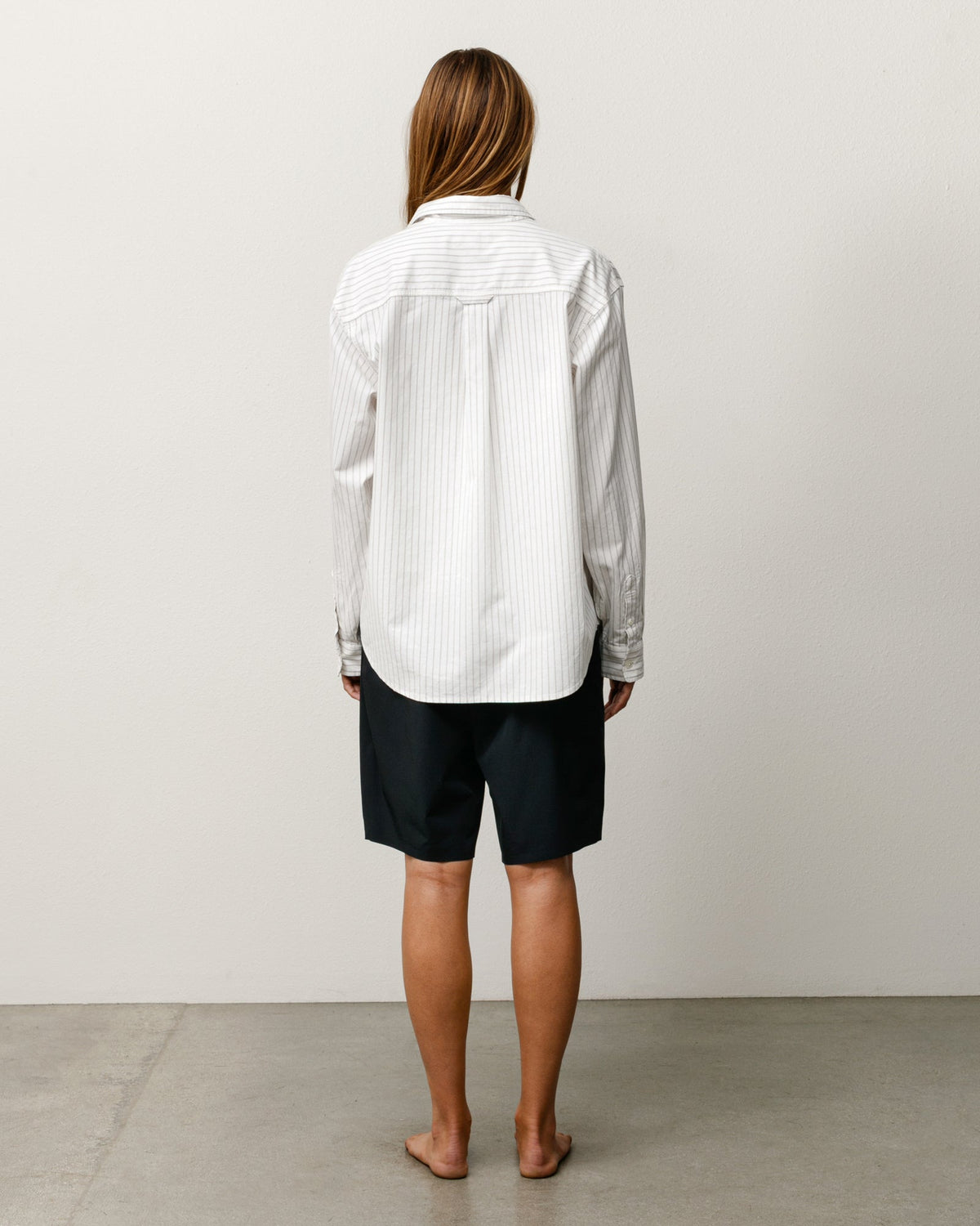 Stüssy Peak Board Short in black, unisex stretch-nylon boardshorts shown on model, back view.