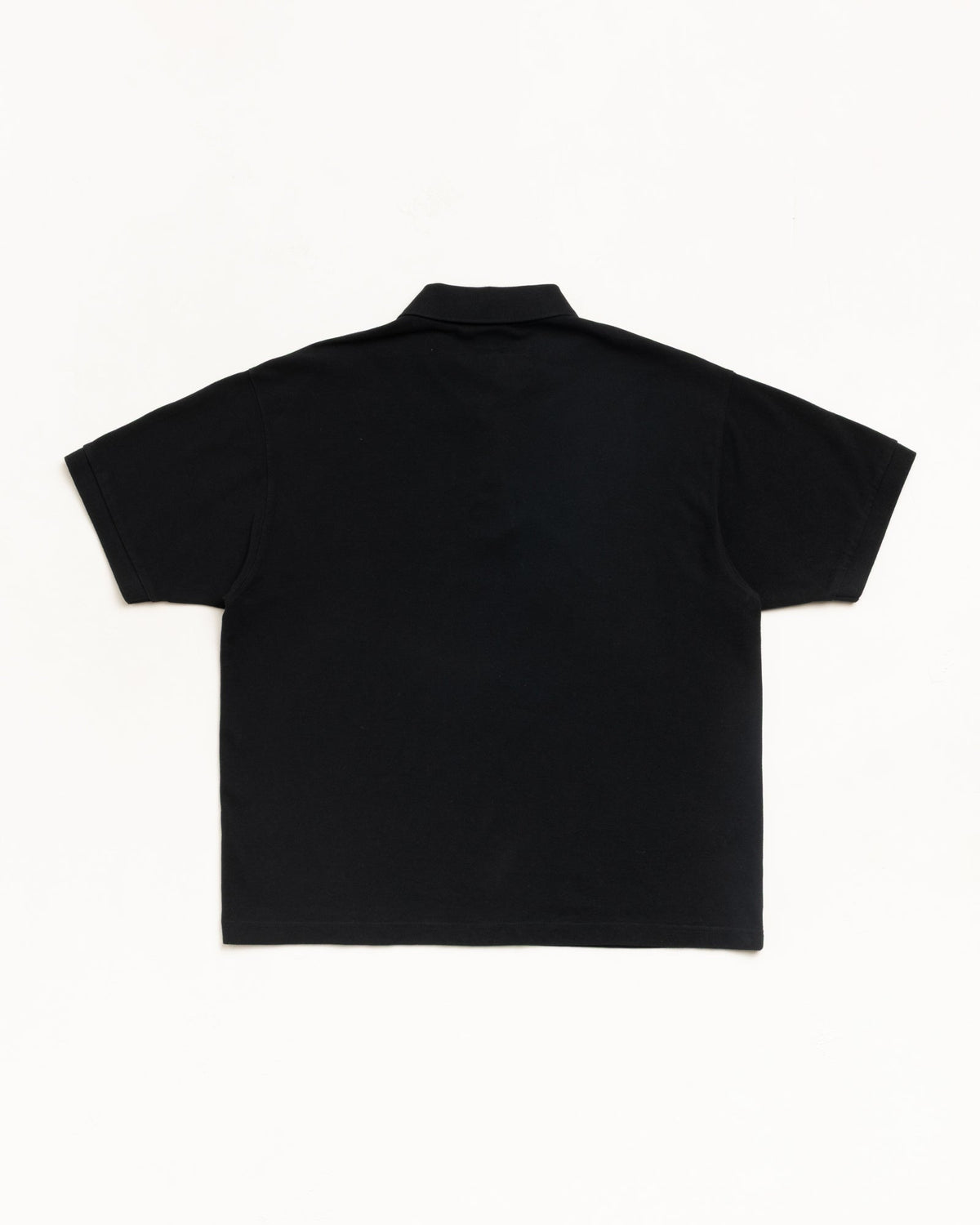 Classic Pique Polo in Black, back view in midweight cotton pique with rib-knit collar and cuffs.