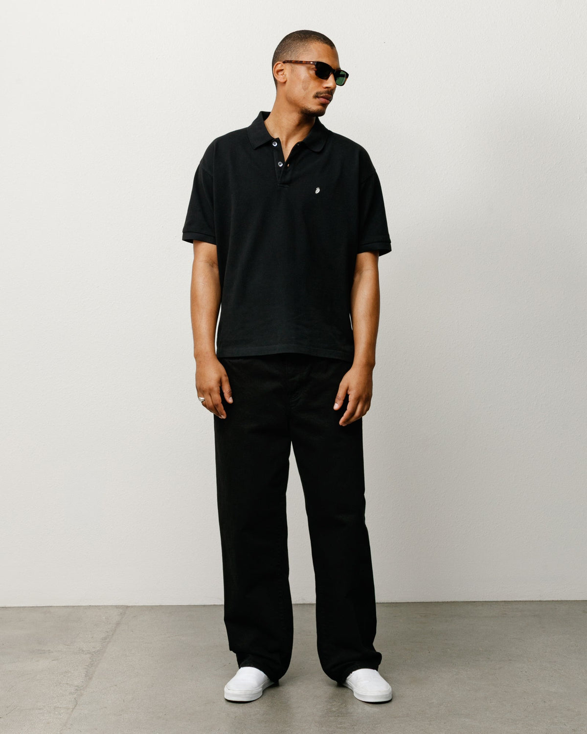 Stüssy Classic Pique Polo in black cotton pique with rib collar and chest S embroidery