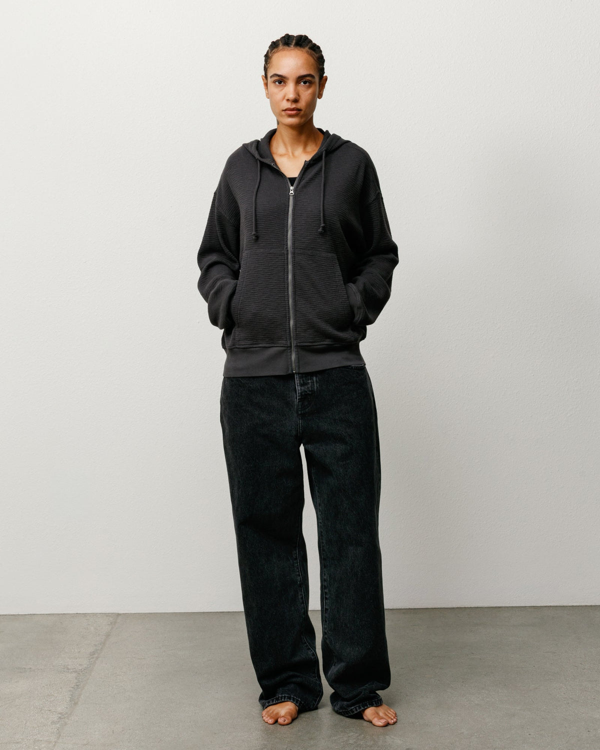 Lightweight Thermal Hoodie in Faded Black, waffle-knit zip style with kangaroo pockets on model.