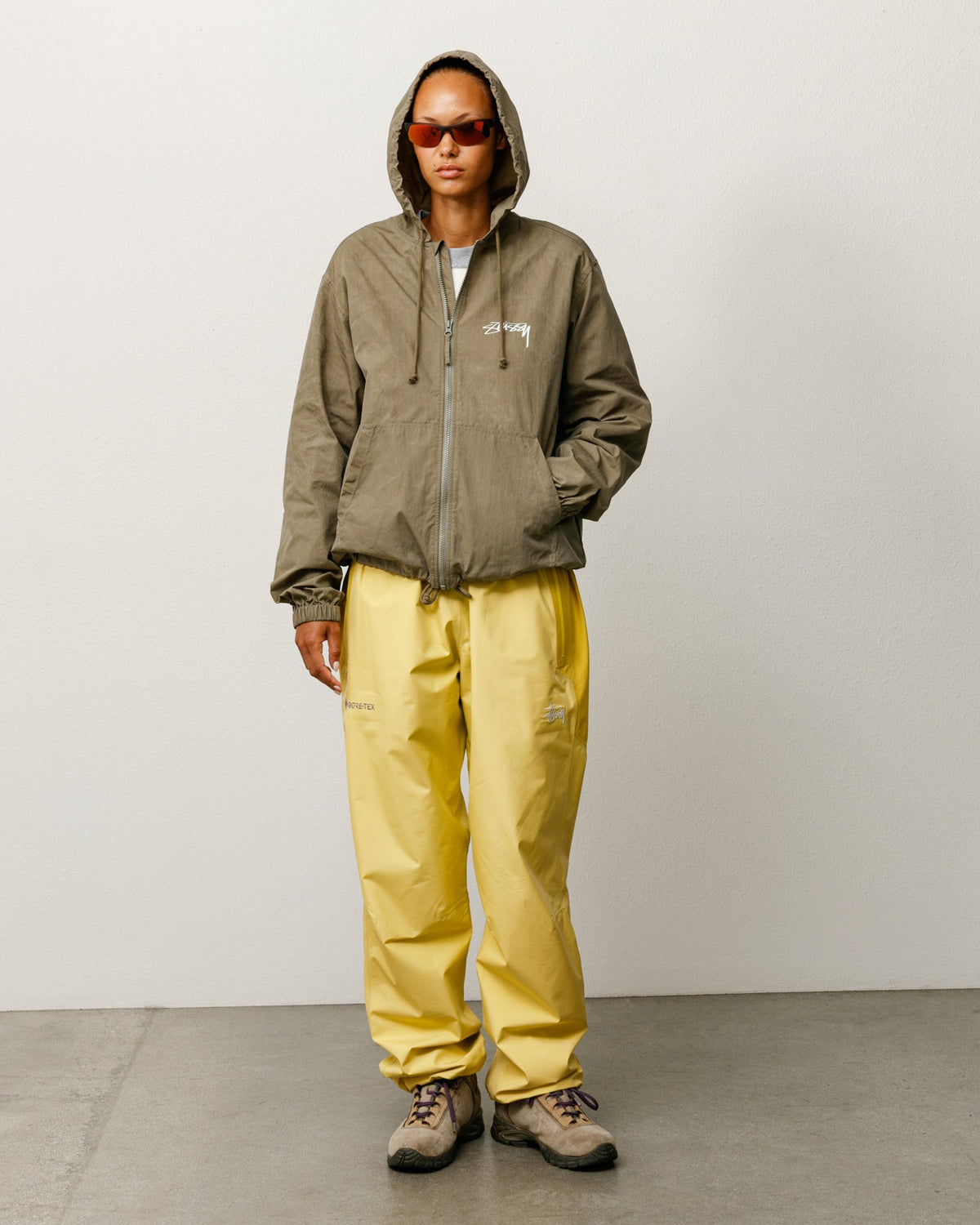 Stüssy Waxed Cotton Beach Shell jacket in olive with hood and chest logo