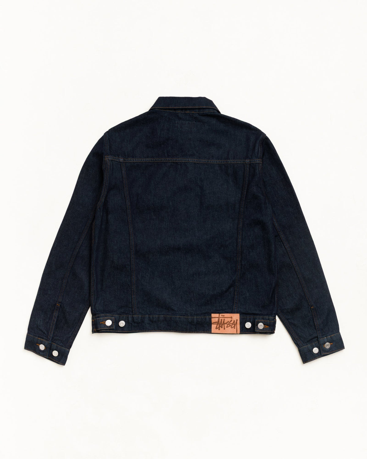 Denim Trucker Jacket in Rinsed Indigo, back view with contrast stitching and suede Stüssy patch