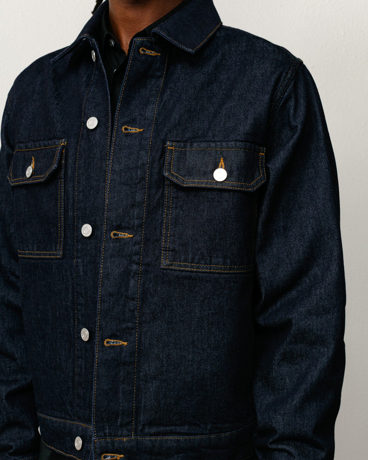 Denim Trucker Jacket in Rinsed Indigo, relaxed boxy fit with contrast stitching and button front.