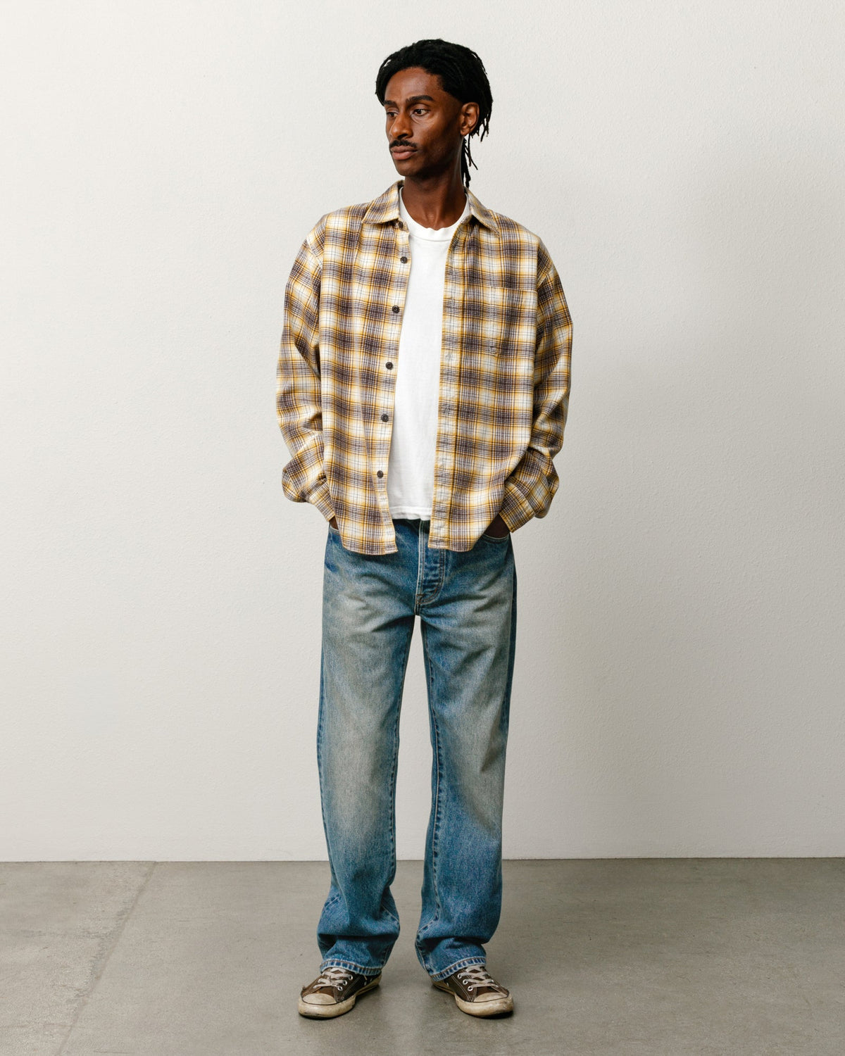 Unisex straight denim jeans in dark wash indigo, relaxed leg silhouette