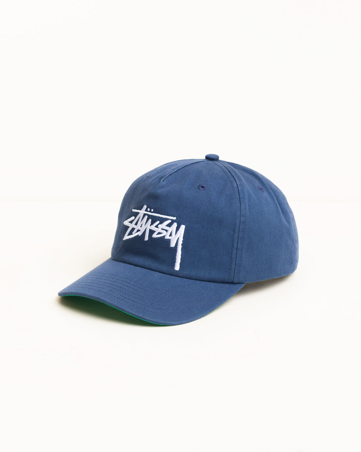 Big Stock Snapback Cap in Deep Blue, washed cotton twill with white Stüssy logo