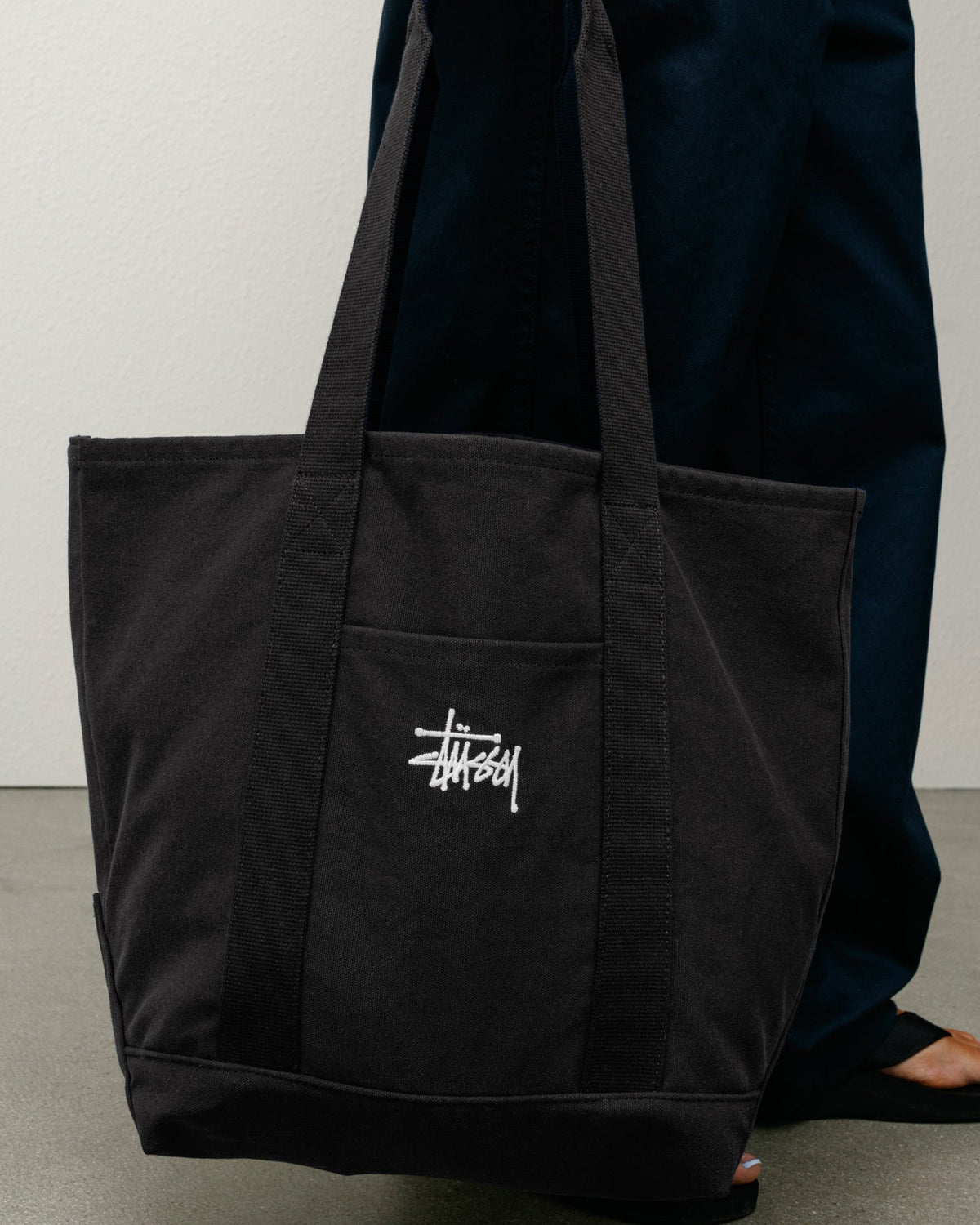 Canvas Market Tote Bag in Black cotton canvas with webbed handles and Stüssy logo