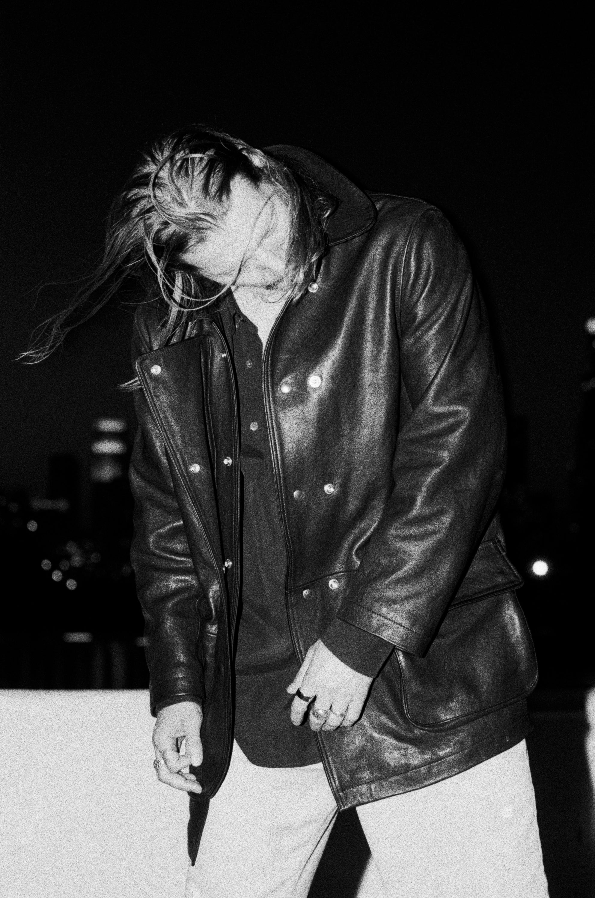 Black and white photo of a model wearing the Our Legacy Leather Fireman Jacket